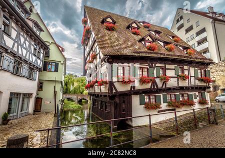 Crooked house or Hotel Schiefes Haus in Ulm, Germany. It is landmark of Ulm located in old Fisherman`s Quarter. View of vintage half-timbered house in Stock Photo